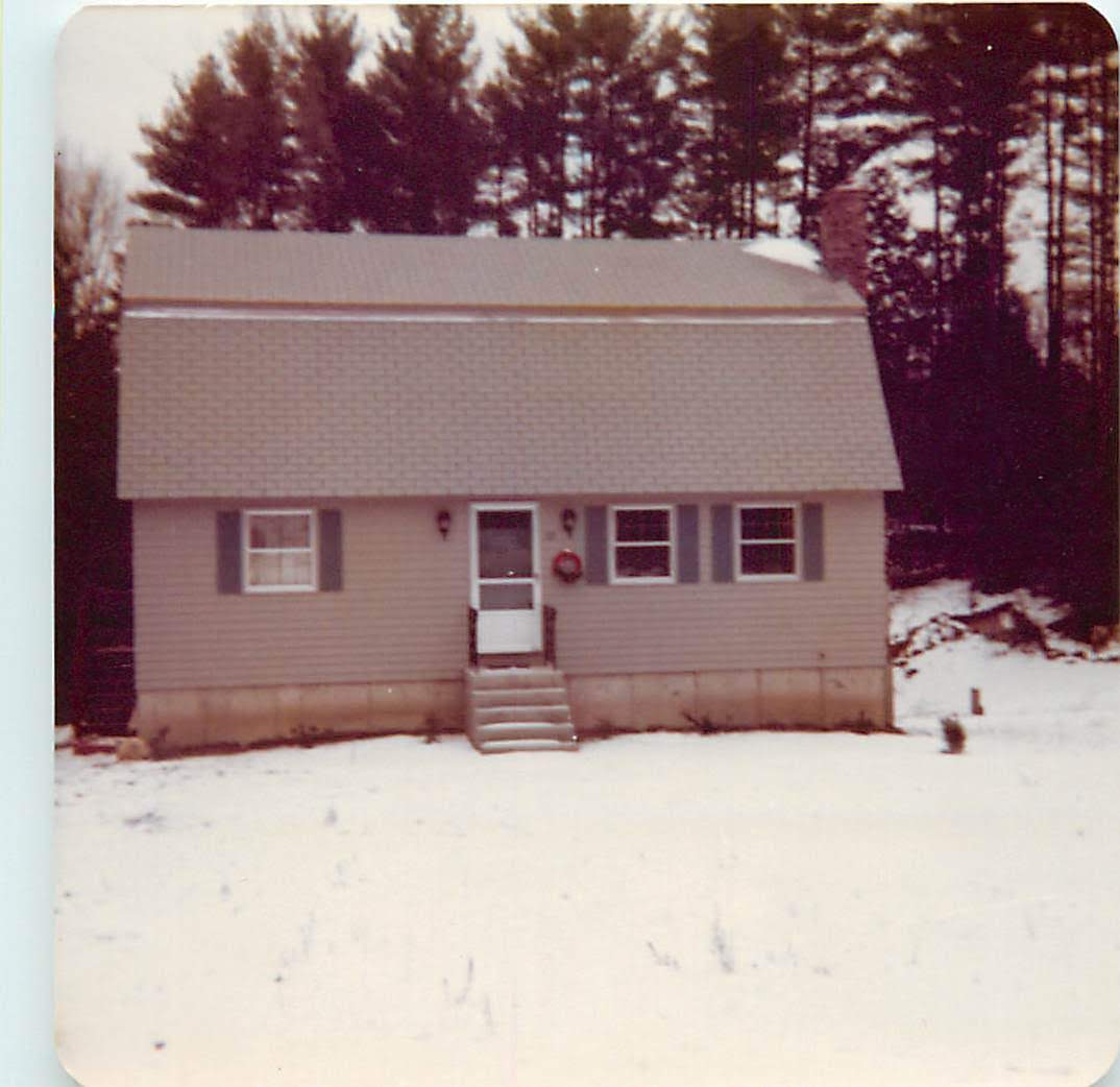 The house in winter, snow on the ground, ordinary New England home